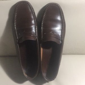 Gently worn brown loafers.